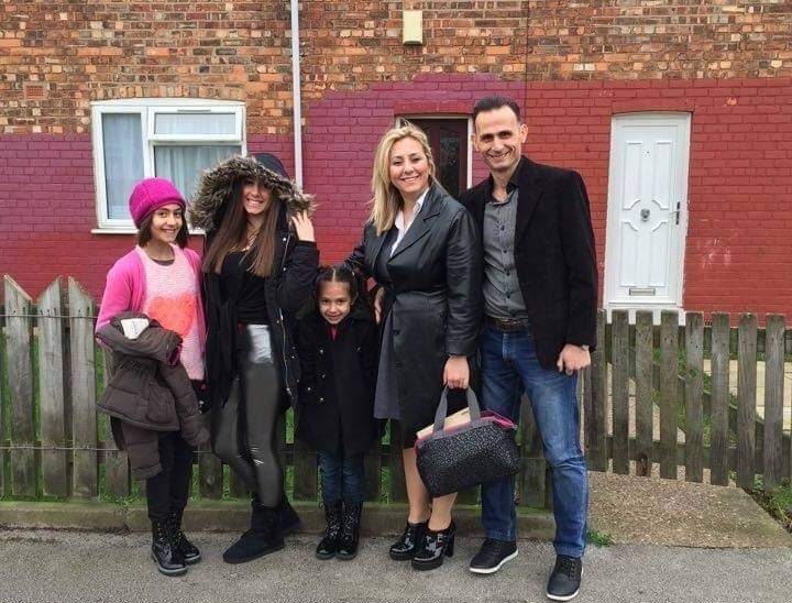 Esther and her family outside their new home in Hull.